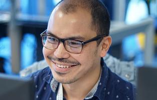 Kai works at his desk